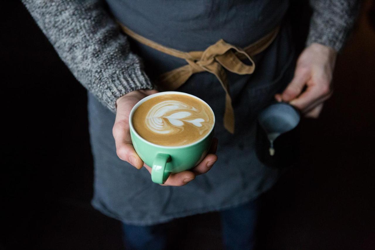 Whitehouse Rye B&B 외부 사진 A barista holding a cup of coffee